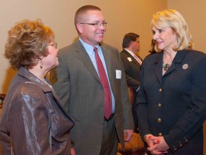 Wanda Frost, executive director of the Moore Home Builders Association, visits with home builder Dan Reeves of Norman and Gov. Fallin.